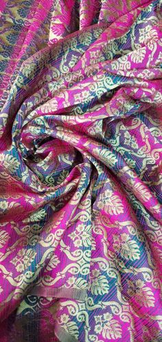 the fabric is very colorful and has an intricate design on it, as well as many colors