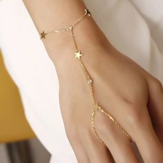 Revel in bohemian charm with our slave bracelet! Featuring shimmering zircon crystals and playful star accents, this unique accessory will have you shining like a star in no time. (Quirky and fun, without taking ourselves too seriously!) Metal: 925 sterling silver Finish: 18k gold Gemstone: white zirconia Bracelet length: adjustable with 4 cm extender (1.5") Chain: cable link Clasp: spring ring Hypoallergenic & nickel-free Don’t forget, proper care of your gold-plated jewelry will preserve its appearance for a long time. Keep it shining bright by using the soft side of the provided JFW polishing cloth