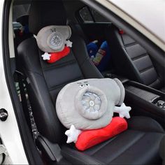 the interior of a car with two stuffed animals in it's seat covers on