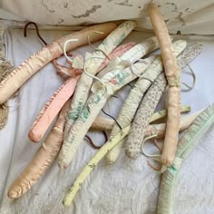 an assortment of wedding garters are laid out on a bed