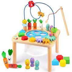 a child's play table with toys on it and an object in the middle