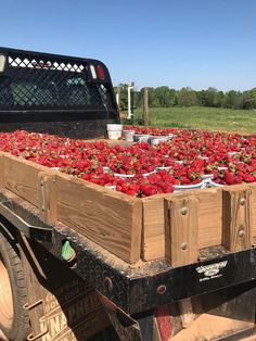 a large truck filled with lots of strawberries