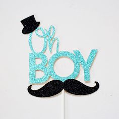 a cake topper that says boy with a mustache