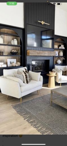 a living room filled with furniture and a fire place in the middle of a room