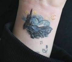 a person with a tattoo on their wrist that has a starr sky and the moon