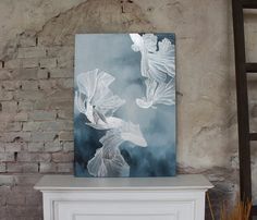 a painting is hanging on the wall next to a white fireplace mantel in a room with brick walls