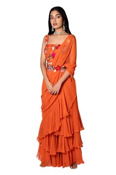 Orange pre-stitched saree with layered ruffles. Paired with floral embroidered blouse and detachable floral embroidered belt.
Component: 3
Embroidered
Neckline: Square
Sleeve Length: Sleeveless
Fabric: Raw Silk, Chiffon
Color: Orange
Embroidered belt - Aza Fashions Stitched Saree, Ruffle Saree, Embroidered Belt, Drape Saree, Embroidered Neckline, Blouse For Women, Fashion App, Saree With Blouse, Blouse Online