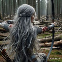 a woman with long gray hair is holding a bow and arrow in the middle of a forest