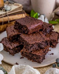 three pieces of chocolate brownie on a plate next to some marshmallows