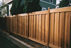 a wooden fence in front of a house