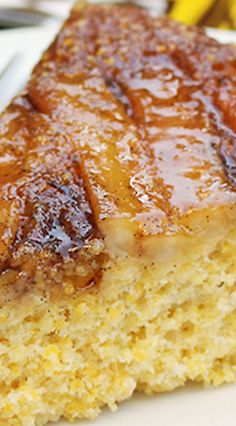 a piece of cake on a plate with bananas in the background