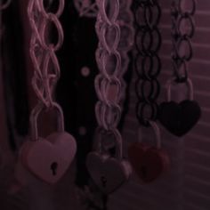 several heart shaped key chains hanging from the ceiling