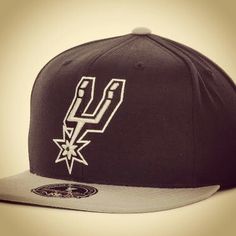 a black and white hat with the san antonio spurs logo on it