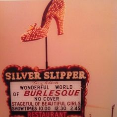 a sign for silver slipper restaurant with a high heeled shoe on it