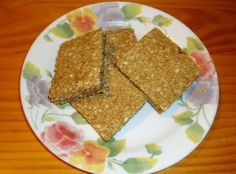 three pieces of crackers on a floral plate