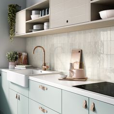 a kitchen with blue cabinets, white counter tops and wooden shelves above the sink area