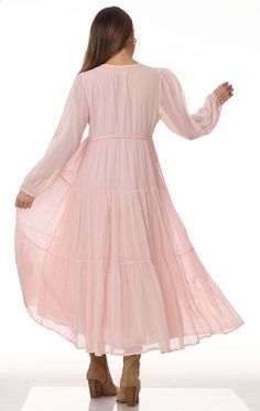 Mylene Embroidered Maxi Dress Long Sleeves Peach This stunning Mylene Embroidered Maxi Dress is the perfect addition to any wardrobe. Made from 100% Indian cotton, this dress is not only stylish but also comfortable to wear. The intricate embroidery adds a touch of elegance to the overall design. The dress comes in two sizes: Small/Medium which fits sizes 2 to 6, and Medium/Large which fits sizes 6 to 10. The long sleeves provide coverage and warmth, making it suitable for any season. The beauti Feminine Flowy Maxi Dress With Floral Embroidery, Flowy Feminine Floral Embroidered Maxi Dress, Flowy Feminine Maxi Dress With Floral Embroidery, Feminine Boho Maxi Dress, Floral Embroidered Midi Dress For Daywear, Floral Embroidery Midi Dress For Daywear, Pink Embroidered Long Sleeve Maxi Dress, Pink Long Sleeve Embroidered Maxi Dress, Flowy Floral Embroidered Dress