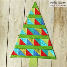 a colorful christmas tree made out of scrap material on a wooden surface with text overlay that says, how to make a patchwork christmas tree