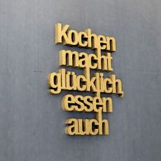 the words are made out of wood and have been cut into smaller letters on it