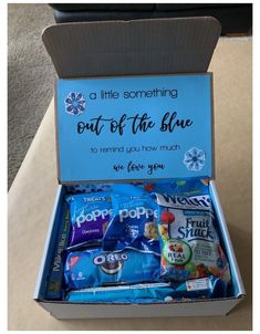 a blue box filled with snacks sitting on top of a table