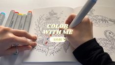 a person is writing on a coloring book