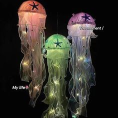 three jellyfish lights in the dark with stars on their heads and underbellies