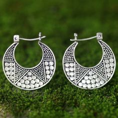 Kenari designs earrings rich in Balinese artistry. The sterling silver hoop earrings are crafted by hand featuring dotted details on one side and a polished finish on the other side. .925 Sterling silver Artisan Silver Round Hoop Earrings, Artisan Hoop Earrings With Oxidized Finish, Artisan Oxidized Hoop Earrings, Sterling Silver Hoop Earrings For Festivals, Festival Sterling Silver Hoop Earrings, Oxidized Sterling Silver Hoop Earrings For Festivals, Sterling Silver Hoop Earrings With Oxidized Finish For Festivals, Sterling Silver Oxidized Hoop Earrings For Festivals, Artisan Silver Small Hoop Earrings