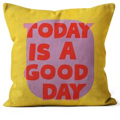 a yellow and pink pillow with the words today is a good day printed on it