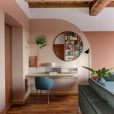 a living room with a couch, table and bookshelf on the wall in front of it