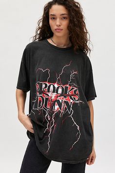 Oversized t-shirt dress featuring a Brooks & Dunn graphic across the front for western flair. Designed in a relaxed fit perfect as an oversized tee or mini dress. Only at Urban Outfitters. Features Brooks & Dunn graphic t-shirt dress Oversized graphic tee Washed soft and faded fabric Crew neckline with drop shoulders and short sleeves Brooks & Dunn graphic across the front Oversized, relaxed fit Tunic length UO exclusive Content + Care 100% Cotton Machine wash Imported Size + Fit Model in Black is 5’9" and wearing size S/M Measurements taken from size S/M Chest: 46" Length: 29.5" | Brooks & Dunn Graphic T-Shirt Dress in Black, Women's at Urban Outfitters Brooks & Dunn, Oversized T Shirt Dress, Fitted Tunic, Oversized Graphic Tee, Tee Shirt Dress, Tees For Women, Oversized T Shirt, Tunic Length, Oversized Tee