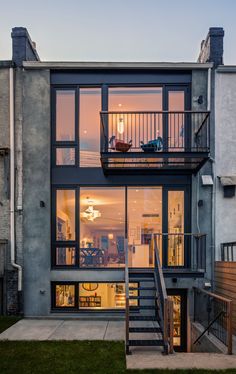 an apartment building with stairs leading up to the upper floor and second story balcony area