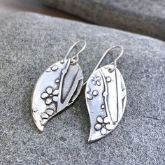 Beautiful silver cherry blossom earrings. Crafted with fine silver metal clay. Each pair is handmade and therefore unique. 100% Sterling Silver Earwire / .999 Fine Silver Feel free to email me with any questions. Additional Information: * Complimentary Gift Box! * All jewelry items come securely packaged and are mailed promptly upon payment - often same-day. * The majority of my vintage items are used and may show some wear. Please review all photos closely. * All measurements are approximate. * Silver Nature-inspired Everyday Earrings, Silver Everyday Nature-inspired Earrings, Silver Nature-inspired Earrings For Everyday, Everyday Silver Nature-inspired Earrings, Whimsical Silver Flower Earrings, Whimsical Handmade Silver Flower Earrings, Nature-inspired Silver Flower Drop Earrings, Whimsical Silver Flower Earrings With Ear Wire, Whimsical Silver Dangle Flower Earrings