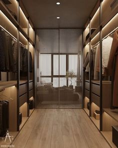 an empty walk - in closet with wooden flooring and sliding glass doors that lead to the bedroom