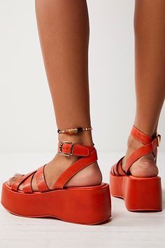 Simple and strappy, these platform sandals feature a lifted sole with a toe loop, criss-cross upper, and a buckle ankle strap. **Features:** Slip-on style, leather uppers, strappy design, toe loop, adjustable buckle ankle strap, flatform sole, lined footbed **Why We | Hazel Flatform Sandals by FP Collection at Free People in Orange, Size: US 8.5 Spring Double Strap Wedge Sandals With Heel Strap, Spring Wedge Sandals With Heel And Double Strap, Summer Toe Loop Sandals With Tang Buckle, Toe Loop Sandals With Tang Buckle For Summer, Bold Sandals With Heel And Ankle Strap, Spring Toe Loop Sandals With Tang Buckle, Summer Wedge Sandals With Single Toe Strap And Platform, Bold Platform Sandals For Spring, Bold Spring Platform Sandals