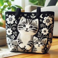 a black and white cat purse sitting on top of a table next to a couch