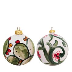 two christmas balls with designs on them sitting next to each other