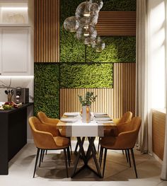 a dining room table with four chairs and a vase on top of it in front of a green wall