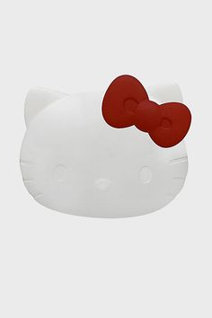 a white hello kitty cat with a red bow on it's head