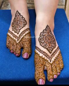 the feet are decorated with henna designs