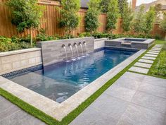 an outdoor pool with water features and landscaping