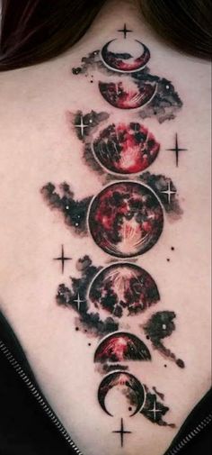 a woman's back with three phases of the moon and stars tattoo on it