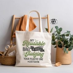 a tote bag sitting on top of a wooden chair next to a potted plant