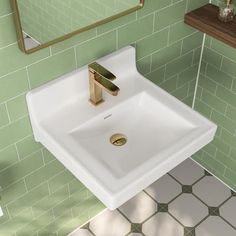 a white sink sitting under a bathroom mirror next to a green tiled wall with gold faucet