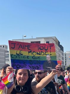 a group of people holding up signs in the street