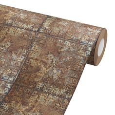 a roll of brown and tan colored carpeting on top of a white background with an intricate pattern