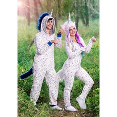 two people in unicorn costumes posing for the camera