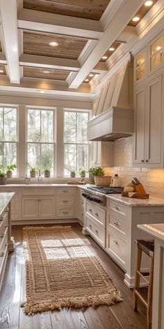 a large kitchen with white cabinets and wooden flooring is pictured in this image from the front view