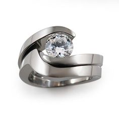 a couple of wedding rings with a diamond in the middle on top of each other