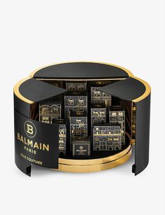 the balmain paris collection is on display in a black and gold box with an open lid