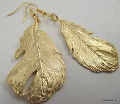 Bold gold feather earrings. You couldn't ask for more! Such detailed, stunning earrings are the perfect accessory for any outfit. Detailed gold plated feathers hang from gold-filled ear wires. The ear wires can be switched out to stainless steel, for those with sensitive ears, or gold plated clip-ons at no additional charge. Simply select your option before adding to your cart. Height from top of ear wire to bottom of feather: approximately 2.75 inches Widest point on wings: 1.0 inch Check the o Gold Feather Earrings, Angel Earrings, Natural Jewelry, Gold Feathers, Stunning Earrings, Guardian Angel, Feather Earrings, Nature Jewelry, Ear Wire